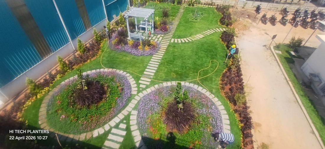 Pergola courtyard with radial flower beds, aerial view