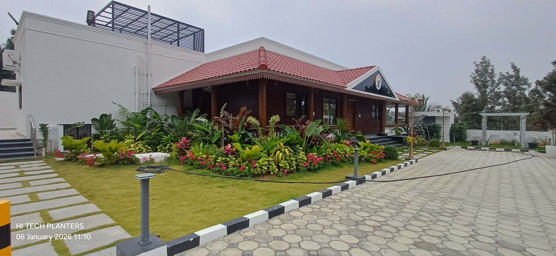 Landscaped clubhouse with tropical planting built by Hi Tech Planters